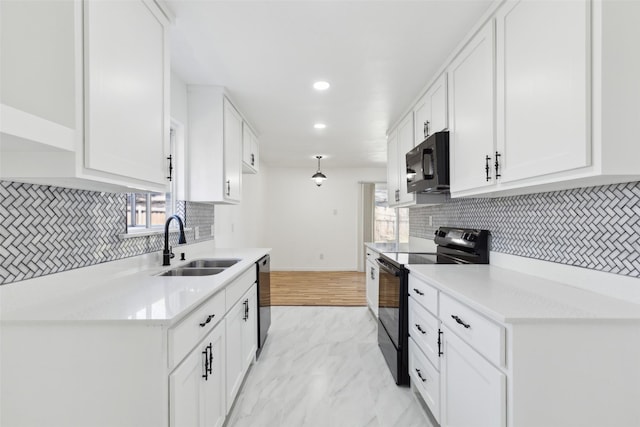 kitchen featuring black appliances, light countertops, marble finish floor, white cabinetry, and a sink