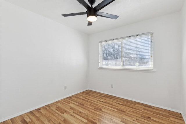 empty room with a ceiling fan, light wood-type flooring, and baseboards