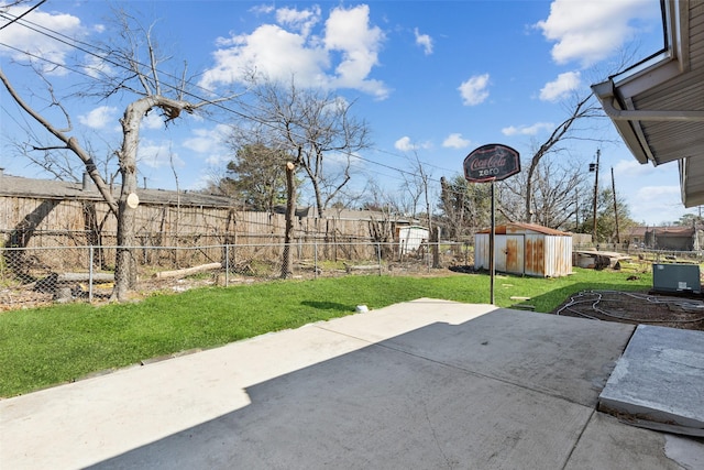 view of patio with a storage shed, an outbuilding, and a fenced backyard