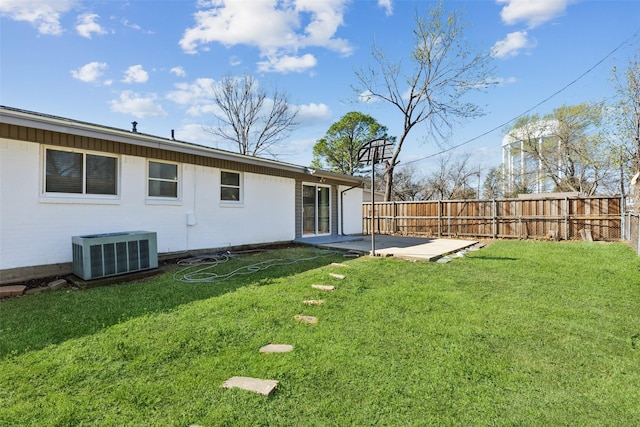 view of yard featuring central AC unit, a patio, and fence