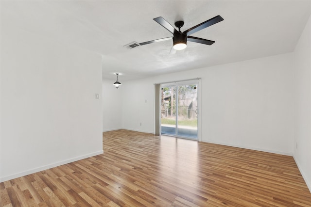 unfurnished room with visible vents, baseboards, light wood-style floors, and a ceiling fan