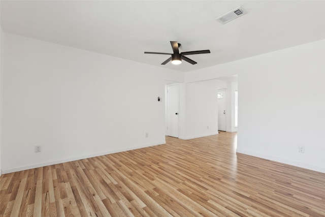 spare room featuring visible vents, baseboards, light wood-style floors, and a ceiling fan