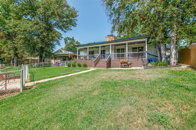 view of front of property with a front yard, covered porch, a fenced backyard, and a chimney