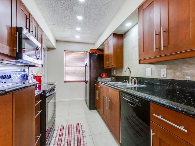 kitchen with dark stone countertops, baseboards, a sink, black appliances, and a textured ceiling