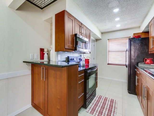 kitchen featuring brown cabinetry, black appliances, a textured ceiling, dark countertops, and backsplash