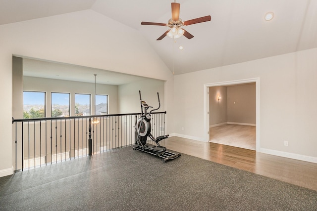 workout room featuring baseboards, high vaulted ceiling, wood finished floors, and a ceiling fan