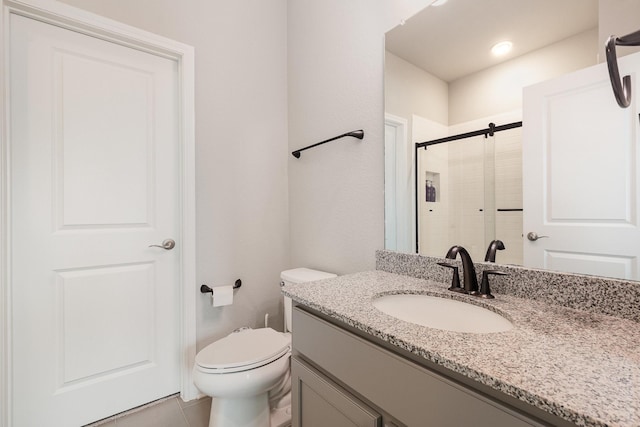 full bath featuring tile patterned floors, toilet, a stall shower, and vanity