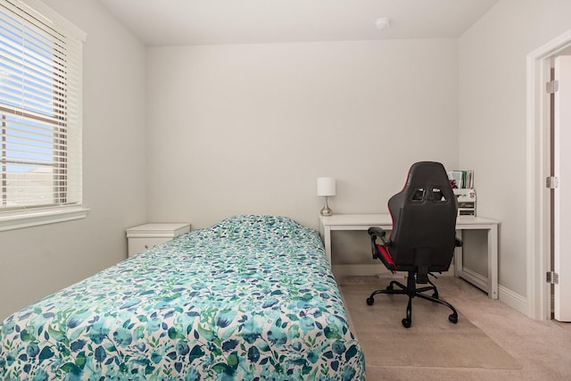 carpeted bedroom with baseboards