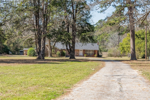 view of front of property with driveway and a front lawn