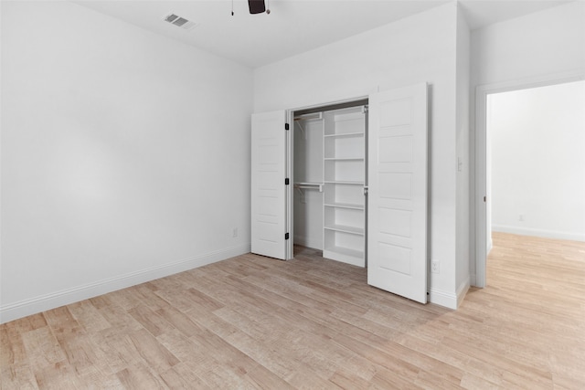 unfurnished bedroom with visible vents, a ceiling fan, light wood-type flooring, and baseboards