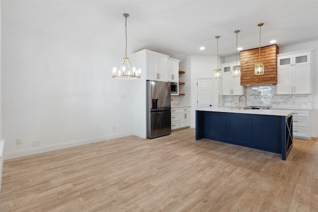 kitchen featuring a notable chandelier, open shelves, backsplash, stainless steel appliances, and light countertops