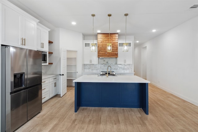 kitchen featuring open shelves, white cabinetry, appliances with stainless steel finishes, light wood finished floors, and light countertops