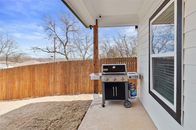 view of patio / terrace featuring grilling area and fence