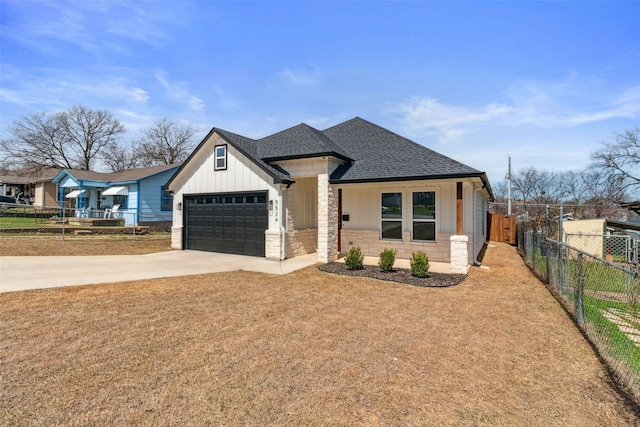 view of front of property featuring stone siding, driveway, a shingled roof, and fence