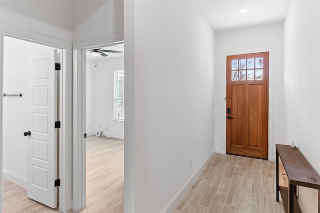 foyer entrance with light wood-type flooring, plenty of natural light, and ceiling fan