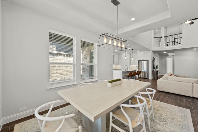 dining area with recessed lighting, baseboards, and dark wood-type flooring