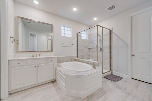 full bathroom featuring visible vents, a shower stall, a garden tub, recessed lighting, and vanity