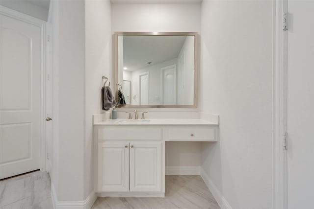 bathroom with vanity, baseboards, and marble finish floor