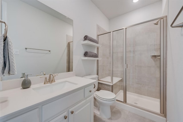 bathroom with vanity, toilet, a shower stall, and tile patterned flooring