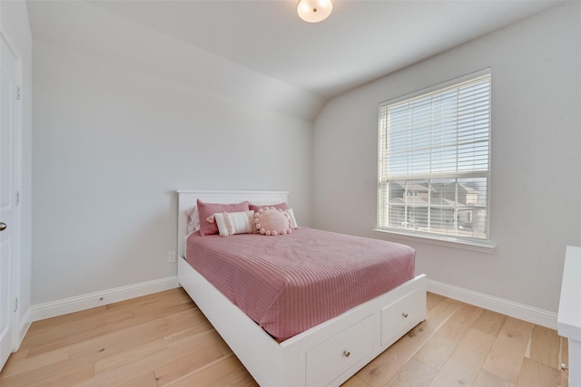 bedroom with light wood-type flooring and baseboards