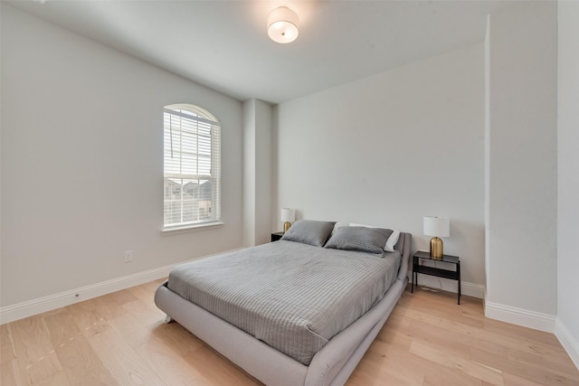 bedroom with baseboards and light wood-style floors