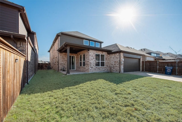 back of house featuring brick siding, concrete driveway, a fenced backyard, a yard, and an attached garage