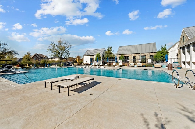 community pool featuring a patio area and fence