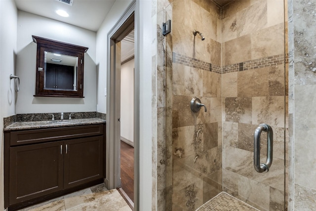 full bath featuring a stall shower and vanity