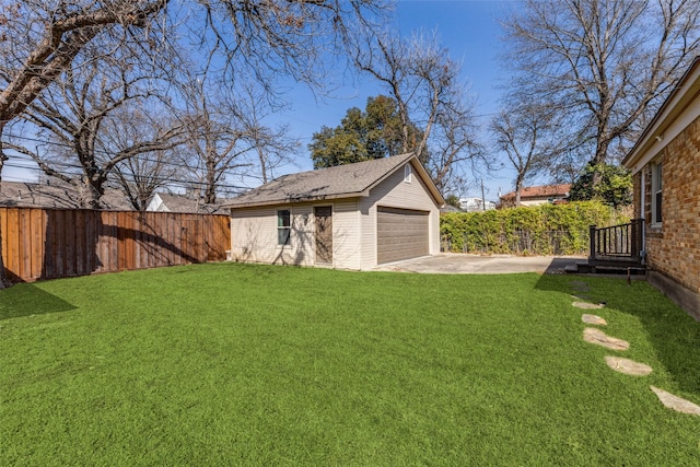 view of yard with a garage, an outdoor structure, and fence