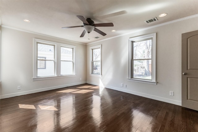 spare room featuring baseboards, wood finished floors, and ornamental molding