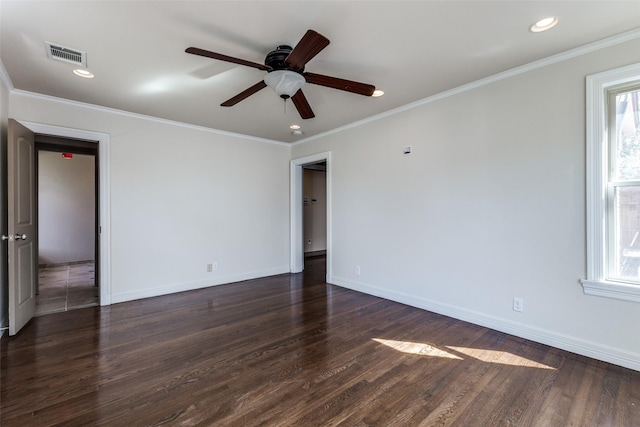 spare room with baseboards, dark wood-style floors, and ornamental molding