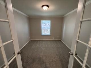 carpeted empty room featuring baseboards and ornamental molding