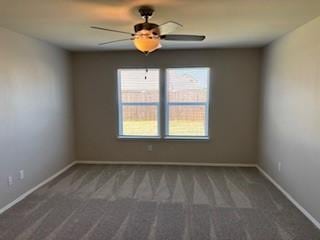 empty room with baseboards, carpet, and a ceiling fan