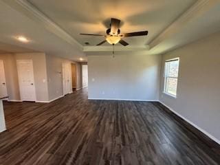 unfurnished living room featuring ceiling fan, dark wood-type flooring, and a tray ceiling