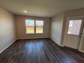 interior space with wood finished floors and baseboards