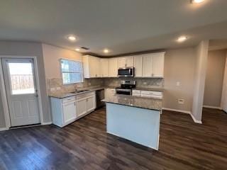 kitchen with stainless steel appliances, dark wood-style floors, and white cabinets