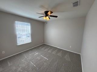 unfurnished room featuring carpet, a ceiling fan, visible vents, and baseboards