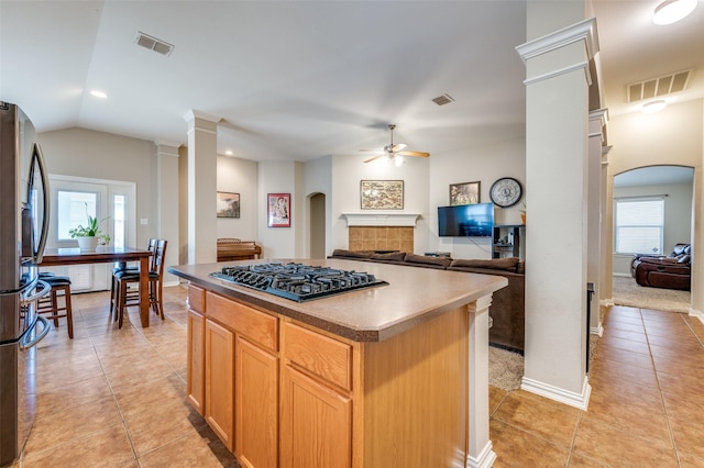 kitchen featuring arched walkways, visible vents, a ceiling fan, and black cooktop