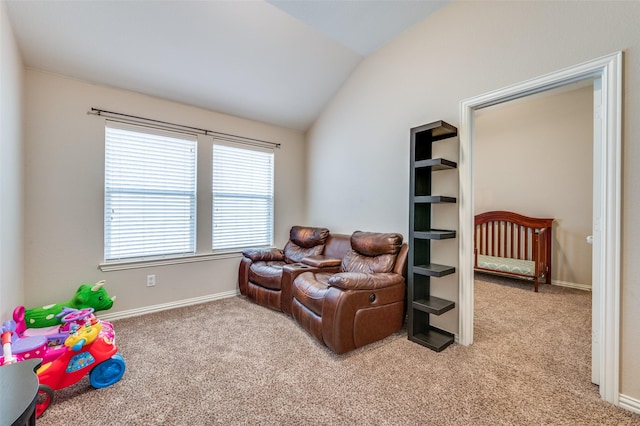 sitting room with baseboards, carpet, and vaulted ceiling