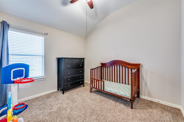 bedroom with carpet flooring, baseboards, a nursery area, and vaulted ceiling