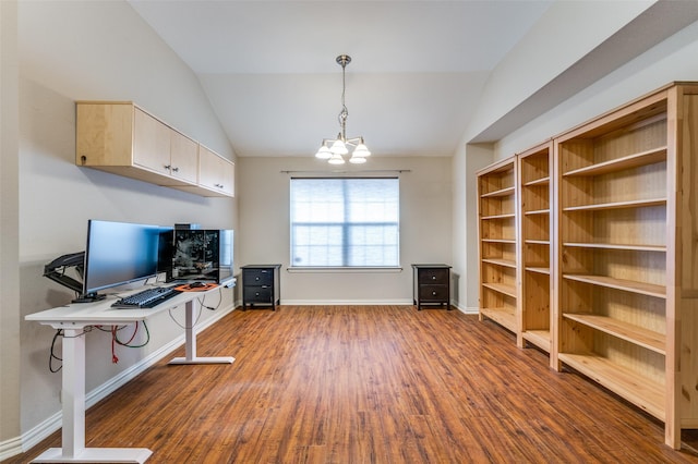 office space featuring baseboards, wood finished floors, an inviting chandelier, and vaulted ceiling