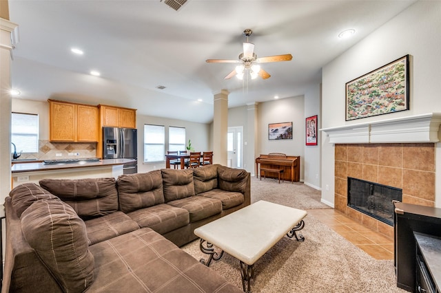 living room featuring a tiled fireplace, light tile patterned floors, recessed lighting, and ceiling fan