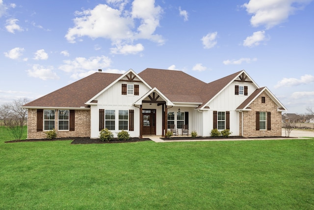 modern farmhouse with board and batten siding, a front yard, and a shingled roof