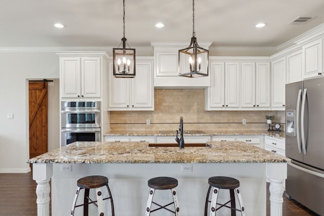 kitchen featuring dark wood finished floors, white cabinets, visible vents, and stainless steel appliances