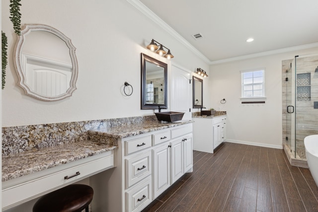 bathroom featuring wood finished floors, visible vents, a stall shower, ornamental molding, and a sink