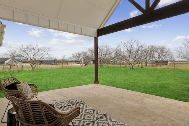 view of patio / terrace featuring a rural view and fence