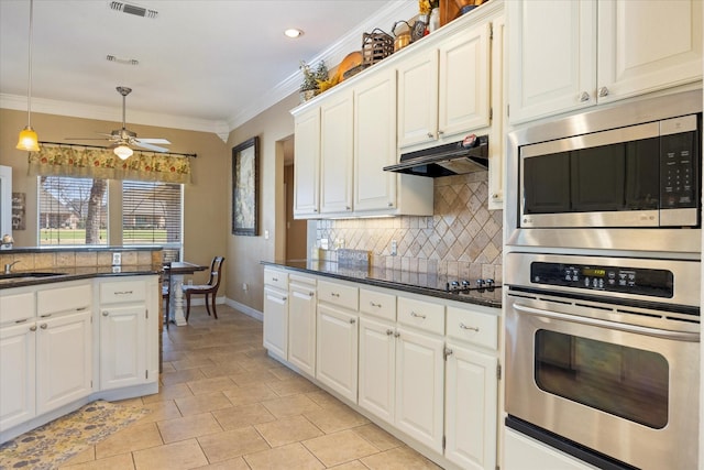 5710 Nutcracker Dr, Granbury, TX 76049 - kitchen featuring stainless steel appliances, under cabinet range hood, backsplash, baseboards, and ornamental molding