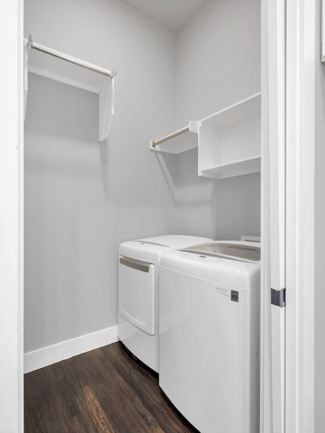 laundry area with laundry area, separate washer and dryer, baseboards, and dark wood-type flooring