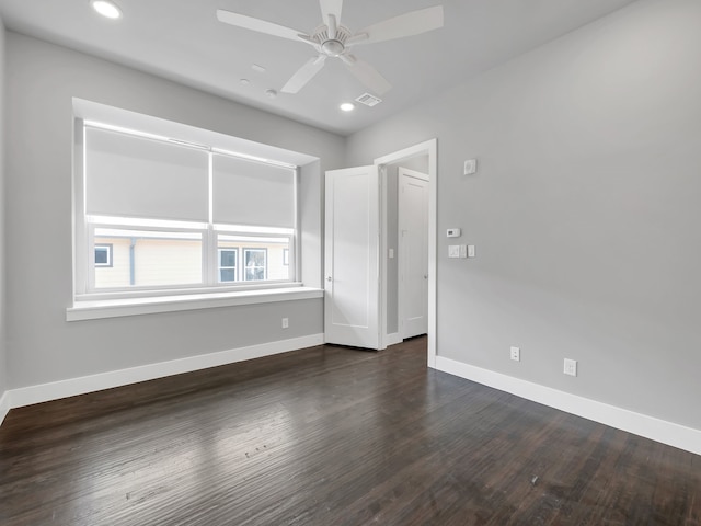 spare room featuring dark wood-style floors, recessed lighting, a ceiling fan, and baseboards