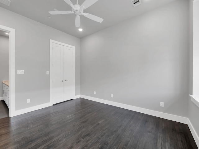 unfurnished room with visible vents, baseboards, recessed lighting, a ceiling fan, and dark wood-style flooring